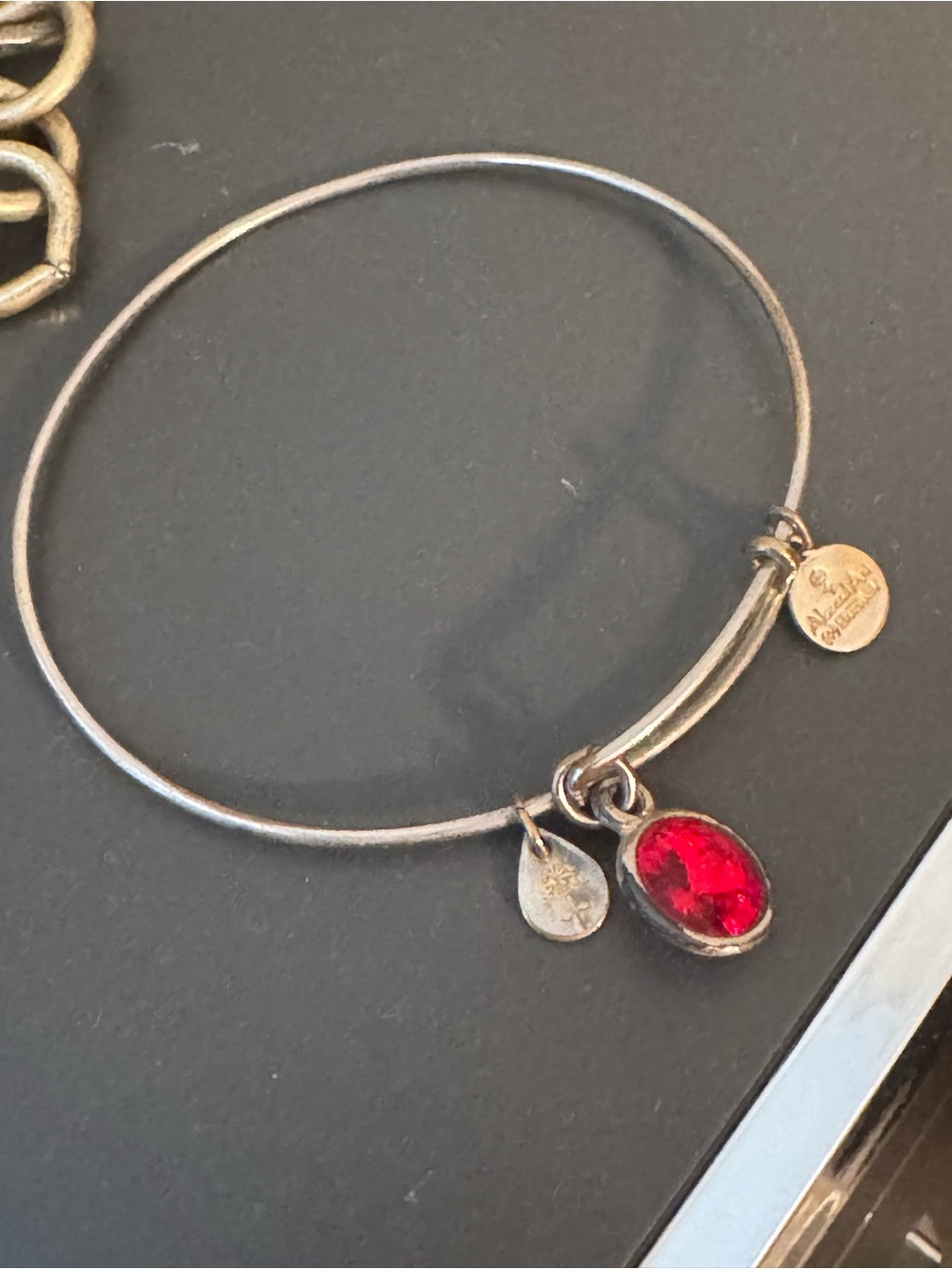 Silver-Tone Bangle Bracelet with Red Gem Charm